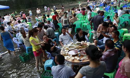 People cool themselves by having dinner on the river bed in Pianyan town, Southwest China's Chongqing on Sunday. Photo: CFP