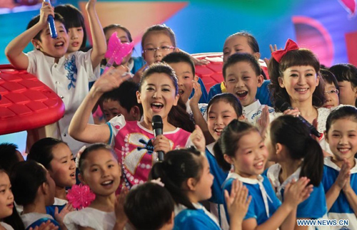 Hostesses from the Children's Channel of China Central Television (CCTV), attend a promoting activity of the channel in Beijing, capital of China, July 7, 2012. A series of new programs will be presented at the channel during the summer vacation. Photo: Xinhua