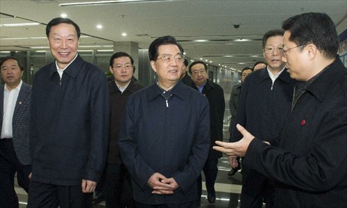 Photo released on December 29, 2012 shows Chinese President Hu Jintao (C) visits China Wireless Valley, a wireless telecom industry base, at the Jiangning Development Zone in Nanjing, capital of east China's Jiangsu Province.