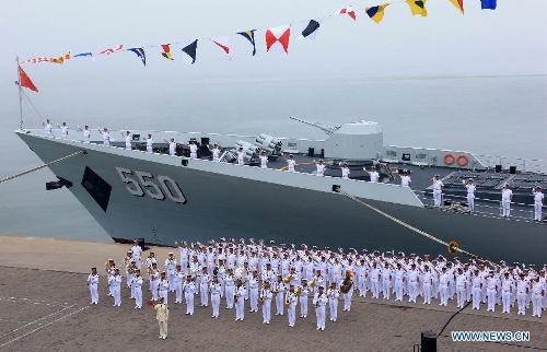 Officers and soldiers of Chinese navy take part in a ceremony for the departure of a fleet in the port of Qingdao, east China's Shandong Province, July 1, 2013. A Chinese fleet consisting of seven naval vessels departed from east China's harbor city of Qingdao on Monday to participate in Sino-Russian joint naval drills scheduled for July 5 to 12. The eight-day maneuvers will focus on joint maritime air defense, joint escorts and marine search and rescue operations. (Xinhua/Zha Chunming)