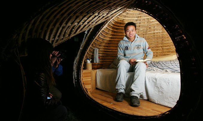 Dai Haifei sits in his egg-shaped house in Beijing in 2010. Photo: CFP