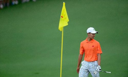 China's Guan Tianlang reacts during the second round of the 2013 Masters golf tournament at the Augusta National Golf Club in Augusta, Georgia, the United States, April 12, 2013. Guan shot a three-over par 75 Friday and stood at four-over 148 after 36 holes. (Xinhua/Scott K. Brown/Augusta National)