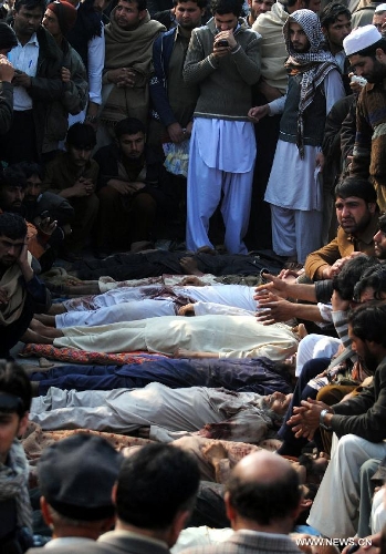 Pakistani villagers from Bara gather around the dead bodies of their relatives during a protest in northwest Pakistan's Peshawar on Jan. 16, 2013. Demonstrators said gunmen wearing military uniforms stormed homes in Bara Tehsil in Khyber Agency, some 30 kilometers from Peshawar, and shot 18 villagers dead in an overnight raid. (Xinhua/Umar Qayyum) 