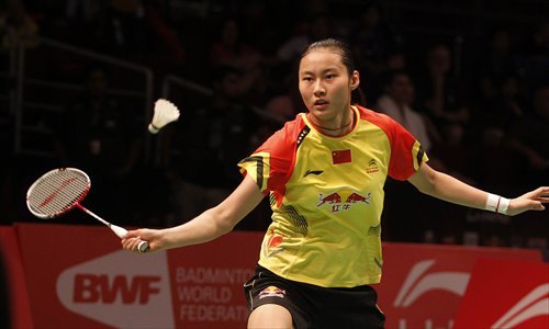 Wang Yihan of China returns a shot against P.V. Sindhu of India during their match at the 2013 Sudirman Cup world mixed team badminton championships in Kuala Lumpur on Sunday. Photo: CFP