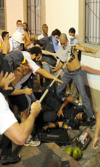 Demonstrators clash with riot police during a protest, the biggest one in 20 years, in front of Rio de Janeiro's Legislative Assembly building on Monday. Tens of thousands of people took to the streets of major Brazilian cities protesting the billions of dollars spent on the Confederations Cup - and preparations for the upcoming World Cup - and against the hike in mass transit fares (see story on page 8).   Photo: AFP