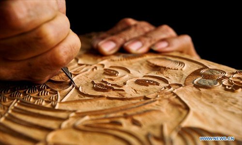 Huo Qingyou, a woodcut new year picture artist, produces a wooden type in Yangliuqing town, north China's Tianjin Municipality, Dec. 28, 2012. In Yangliuqing, dubbed 