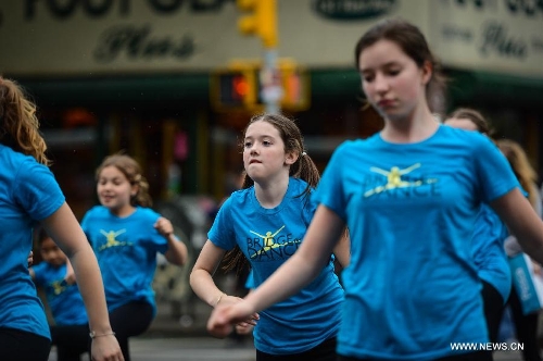 People participate in the annual Dance Parade in New York, on May 18, 2013. Over 200 dance groups showcasing 80 unique dance styles and cultures gathered from Broadway to the East Village on Saturday for the 7th Dance Parade in New York. (Xinhua/Niu Xiaolei) 