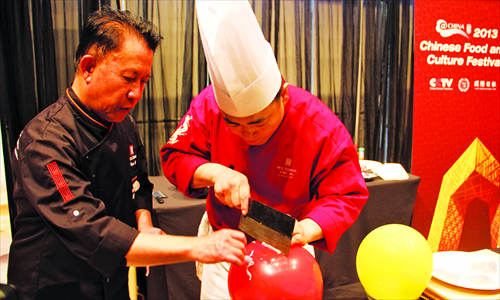 A cook cuts meat on a balloon under the direction of Martin Yan, renowned Chinese-born American chef and TV host. The 2013 Chinese food and culture festival, hosted by CCTV, kicked off on April 22. Photo: Chen Yiming