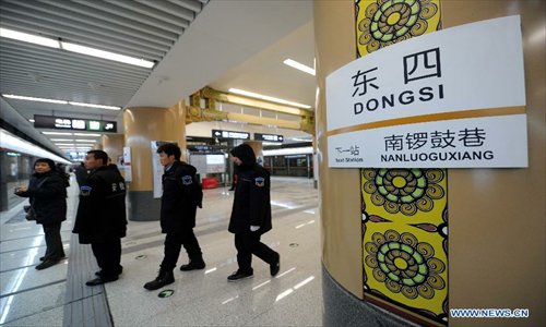 People wait on a platform at the Dongsi Station of the newly-opened subway line 6 in Beijing, capital of China, December 30, 2012. 