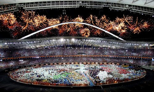 Fireworks light up the sky behind the Olympic Stadium during the opening ceremony of the 28th Olympic Games on August 13, 2004 in Athens. Photo: IC