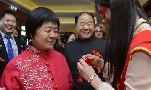 Chinese writer Mo Yan (2nd R), the 2012 Nobel Prize winner for literature, and his wife (2nd L) attend a reception by Chinese entrepreneurs in Stockholm, capital of Sweden, December 8, 2012. Photo: Xinhua