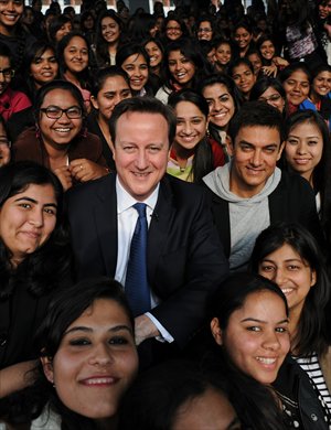 Prime Minister David Cameron poses with Bollywood superstar Aamir Khan (right) as he meets students at Janki Devi Memorial College, a women's college, in Delhi, India on Tuesday during the second day of his three-day visit to the country. Photo: CFP