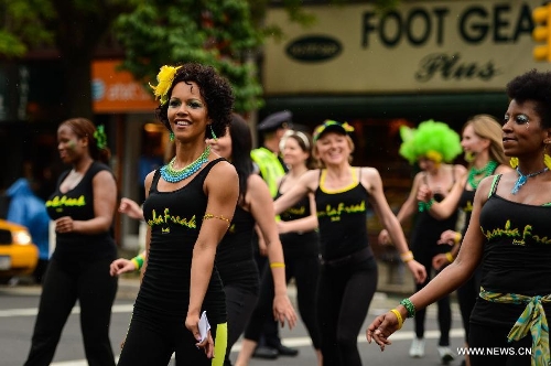 People participate in the annual Dance Parade in New York, on May 18, 2013. Over 200 dance groups showcasing 80 unique dance styles and cultures gathered from Broadway to the East Village on Saturday for the 7th Dance Parade in New York. (Xinhua/Niu Xiaolei) 