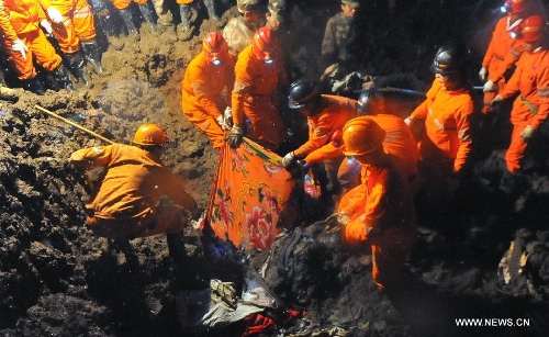  Rescuers find a victim's body at the mud-inundated debris after a landslide hit Gaopo Village in Zhenxiong County, southwest China's Yunnan Province, Jan. 11, 2013. The death toll from a landslide that hit Gaopo Village on Friday has risen to 42, after more bodies were retrieved. Two injured people have been sent to a nearby hospital, and it has been confirmed that their injuries are not life-threatening. (Xinhua/Chen Haining)