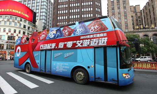 A bus with signs calling for action to eradicate AIDS travels through downtown Shanghai on December 1, 2012, World AIDS Day. Photo: CFP
