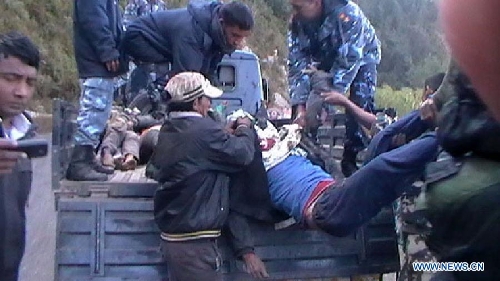 Nepalese police examine the bodies of victims in a bus accident at Doti, Nepal, Jan. 12, 2013. At least 30 people were killed and 13 others injured when a passenger bus veered off a mountain road at Doti. (Xinhua)