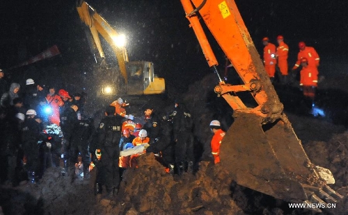 Rescuers and excavators work at the mud-inundated debris after a landslide hit Gaopo Village in Zhenxiong County, southwest China's Yunnan Province, Jan. 11, 2013. The death toll from a landslide that hit Gaopo Village on Friday has risen to 42, after more bodies were retrieved. Two injured people have been sent to a nearby hospital, and it has been confirmed that their injuries are not life-threatening. (Xinhua/Chen Haining) 