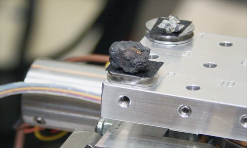 A handout photo taken on Monday, and provided by Urals Federal University shows pieces of porous black rock, reportedly fragments of the meteor that spectacularly plunged over Russia's Ural Mountains. Photo: AFP