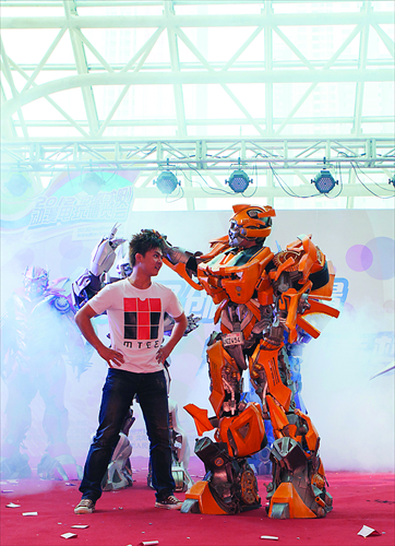 Chinese cosplay enthusiast Mei Luo dressed as the Transformer Bumblebee poses with a fan. Photo: Courtesy of Mei Luo