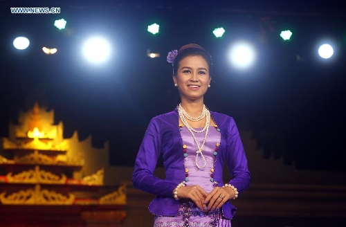 A model presents traditional costumes during the Myanmar women's traditional culture and dressing style show at the National Theater in Yangon, Myanmar, June 29, 2013. The show was held here in commemoration of Myanmar Women's Day falling on July 3. (Xinhua/U Aung) 