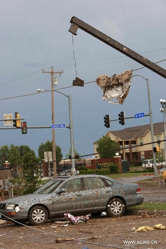 A destroyed car is seen in Moore, Oklahoma, May 21, 2013, one day after a tornado moved through the area. A powerful tornado attacked on Monday afternoon the southern suburbs of the Oklahoma City, capital of the U.S. state of Oklahoma, killing at least 24 people, including 9 children. (Xinhua/Song Qiong)