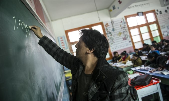A teacher gives a lesson in Tibetan at a bilingual primary school in Aba, Sichuan Province on March 4.