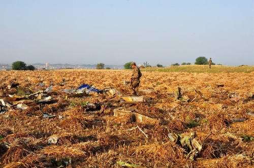 A Pakistani soldier searches the plane crash site on the outskirts of Islamabad, capital of Pakistan, on April 21, 2012. All passengers and the crew aboard a Pakistani plane that crashed near Islamabad have been declared dead after the rescue teams found the wreckage, the country's Interior Minister Rehman Malik said.(Xinhua/Ahmad Kamal)