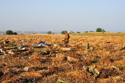 A Pakistani soldier searches the plane crash site on the outskirts of Islamabad, capital of Pakistan, on April 21, 2012. All passengers and the crew aboard a Pakistani plane that crashed near Islamabad have been declared dead after the rescue teams found the wreckage, the country's Interior Minister Rehman Malik said.(Xinhua/Ahmad Kamal)