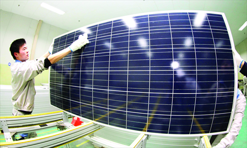 A worker checks a solar panel for export to Europe in Lianyungang, East China's Jiangsu Province Monday. Hong Kong-based solar farm operator Sky Solar recently completed two photovoltaic projects in Japan with a total capacity of 2.3 megawatts. The firm, backed by the China Development Bank, said Monday that it aims to start another 30 new projects simultaneously in Japan from May. Photo: CFP