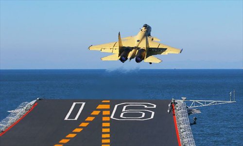 This undated photo shows a carrier-borne J-15 fighter jet taking off from China's first aircraft carrier, the Liaoning. China has successfully conducted flight landing on its first aircraft carrier, the Liaoning. After its delivery to the People's Liberation Army (PLA) Navy on Sept. 25, the aircraft carrier has undergone a series of sailing and technological tests, including the flight of the carrier-borne J-15. Capabilities of the carrier platform and the J-15 have been tested, meeting all requirements and achieving good compatibility, the PLA Navy said. Designed by and made in China, the J-15 is able to carry multi-type anti-ship, air-to-air and air-to-ground missiles, as well as precision-guided bombs. The J-15 has comprehensive capabilities comparable to those of the Russian Su-33 jet and the U.S. F-18, military experts estimated. Photo: Xinhua