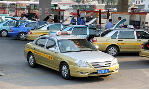 A taxi leaves a natural gas station in East China's Nanjing, capital of Jiangsu Province. Such taxis have recently had to wait at least an hour to get gas because demand has increased due to the recent hot weather. Photo: CFP