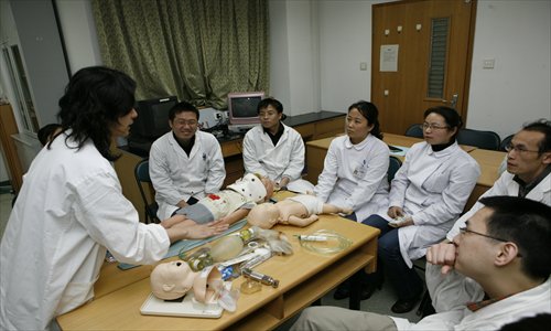 Tutors from Project HOPE and the Shanghai Children's Medical Center demonstrate child resuscitation techniques. Photo: Courtesy of Project HOPE