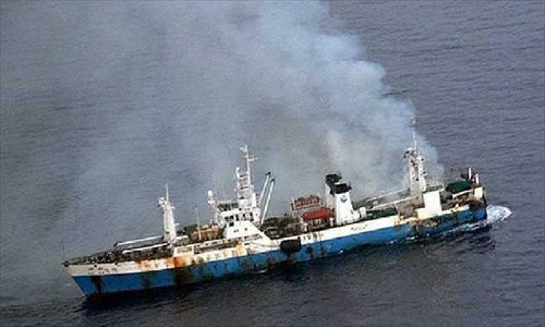 Image provided by the Communications Office of the Chilean Air Force shows smoke rising from Chinese fishing vessel