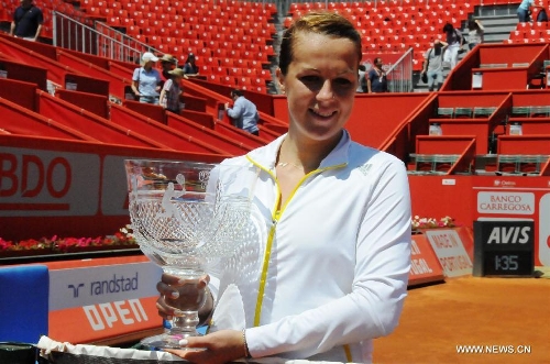 Anastasia Pavlyuchenkova of Russia poses with the trophy after the women's singles final match against Carla Suarez Navarro of Spain at the 2013 Portugal Open in Lisbon, Portugal, May 4, 2013. Pavlyuchenkova won 2-0 to claim the title. (Xinhua/Zhang Liyun) 