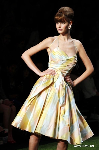 A model presents a creation by Austrian designer Lena Hoschek at the Spring/Summer 2014 Shows of the Mercedes-Benz Fashion Week, in Berlin, on July 2, 2013. (Xinhua/Pan Xu) 