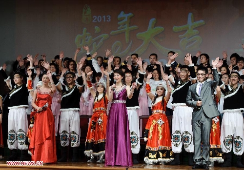 Chinese students studying in Russia&nbsp;take&nbsp;curtain call&nbsp;and wave hands to audiance during a performance staged at the Chinese Embassy in Moscow, Russia, Jan. 20, 2013. The performance was held here on Sunday in celebration of China's traditional Spring Festival and the upcoming Year of the Snake. (Xinhua/Jiang Kehong)