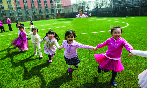 Children hold hands at the Canadian International School of Beijing's Pink Shirt Day. The anti-bullying event started in Canada in 2009. Photos: Li Hao/GT