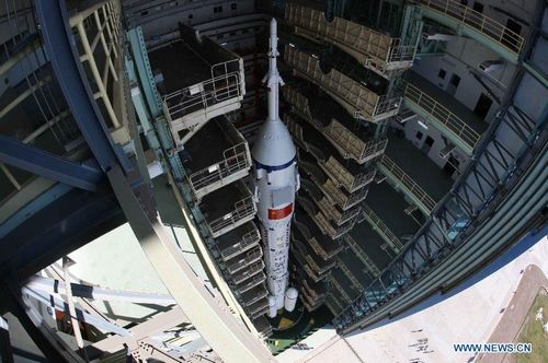 The Shenzhou-9 manned spacecraft, the Long March-2F rocket, and the escape tower wait to be vertically transferred to the launch pad at the Jiuquan Satellite Launch Center in northwest China's Gansu Province, June 9, 2012. China will launch its Shenzhou-9 manned spacecraft sometime in mid-June to perform the country's first manned space docking mission with the orbiting Tiangong-1 space lab module, a spokesperson with the country's manned space program said Saturday. Photo: Xinhua
