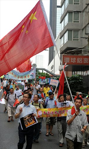 Activists rally during an anti-Japan protest in Hong Kong on Sunday. Members of the Hong Kong Federation of Trade Unions waved Chinese flags and chanted slogans such as 