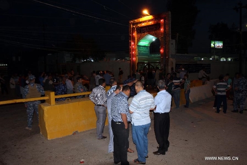 People gather at the blast site at a Shiite mosque in Kirkuk, northern Iraq, May 16, 2013. At least 12 people were killed and 25 others injured as a suicide bomber blew himself up at a Shiite mosque in northern Iraq's Kirkuk on Thursday, local police sources said. (Xinhua/Dena Assad) 