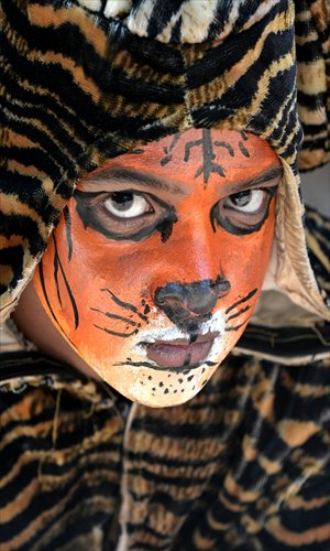 An Indian school child with a painted face takes part Thursday in the 