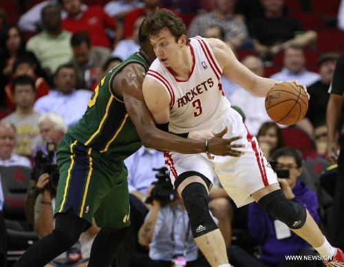 Houston Rockets' Omer Asik (R) drives the ball during the NBA basketball game against Utah Jazz, March 20, 2013, in Houston. Rockets beat Jazz 100-93.(Xinhua/Song Qiong)&nbsp; 