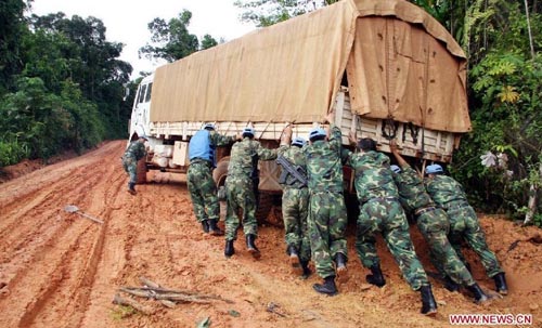 Members of a Chinese peacekeeping troop push a truck trapped in mud during a transport mission from Monrovia to Voinjama, Liberia, June 2, 2006. Over the two decades since it sent its first peacekeeping troop to Cambodia in April 1992, China has participated in more than 20 UN peacekeeping missions, dispatching a total of 20,000 soldiers. There are now nearly 2,000 Chinese peacekeepers carrying out their tasks in 12 peacekeeping missions. Chinese peacekeeping troops are formed by members of the People's Liberation Army (PLA), which will celebrate its 85th founding anniversary on August 1, 2012. Photo: Xinhua