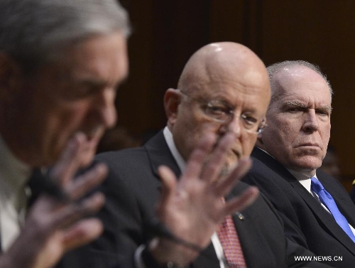 (L to R) FBI Director Robert Mueller, Director of National Intelligence James Clapper, and CIA Director John Brennan testify before the Senate Select Intelligence Committee during a hearing on 