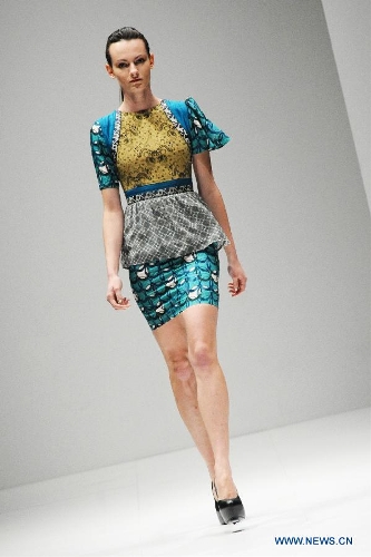 A model presents a creation by Singaporean designer Ong Shunmugam during the Audi Fashion Festival held in Singapore's Marina Bay, May 18, 2013. (Xinhua/Then Chih Wey)