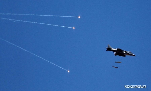 A fighter jet fires flares during Eager Lion multinational military maneuvers in Quweira, 186 miles south of Amman, Jordan, Wednesday, June, 19, 2013. The 12-day exercise involves combined air, land and sea maneuvers across Jordan. Along with Jordan and the U.S., the exercise brings together some 8,000 personnel from 19 Arab and European nations to train on border security, irregular warfare, anti-terrorism and counterinsurgency. (Xinhua/Mohammad Abu Ghosh) 