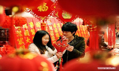 A couple select ornaments for the coming Spring Festival in Sizhou Town of Dexing City, east China's Jiangxi Province, Feb. 8, 2013. The Spring Festival, the most important occasion for the family reunion for the Chinese people, falls on the first day of the first month of the traditional Chinese lunar calendar, or Feb. 10 this year. Photo: Xinhua