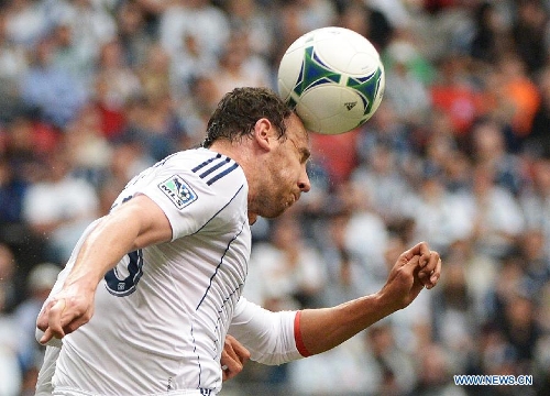 Vancouver Whitecaps' Andy O'Brian heads a ball during a MLS soccer game against Portland Timbers in Vancouver, Canada, on May 18, 2013. The match ended with a 2-2 tie. (Xinhua/Sergei Bachlakov) 