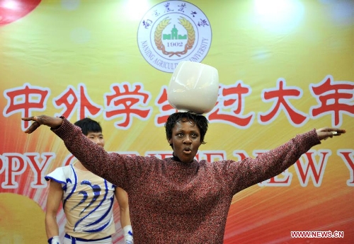 An overseas student performs acrobatics in an activity to celebrate the Chinese New Year at the Nanjing Agricultural University in Nanjing, capital of east China's Jiangsu Province, Feb. 4, 2013. More than 50 overseas students from over 20 countries and regions experienced Chinese traditional cultural activities with local students. (Xinhua)&nbsp; 