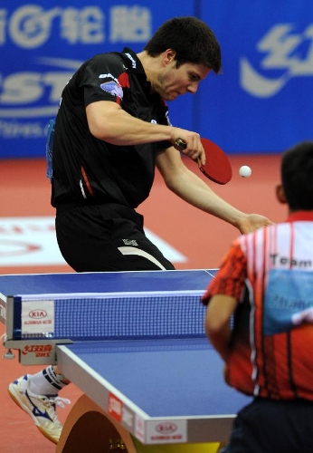Germany' Dimitrij Ovtcharov (L) of Team Europe returns the ball during the match against China's Zhang Jike of Team Asia at the 2013 Asia-Europe Table Tennis All Stars Challenge in Qingdao, east China's Shandong Province, March 17, 2013. Team Asia won 7-3. (Xinhua/Li Ziheng) 